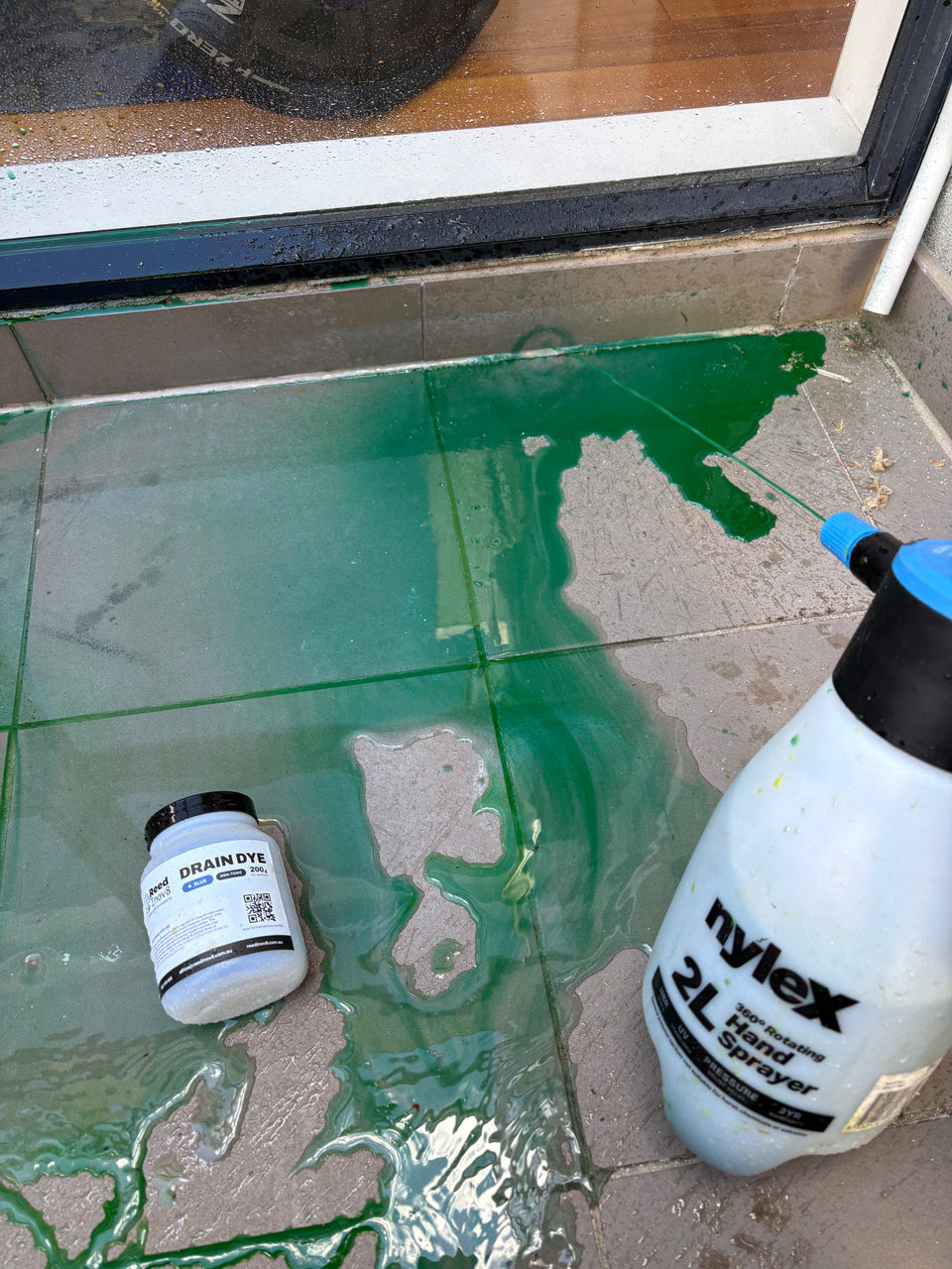 Green Drain Dye solution being introduced at a test point.