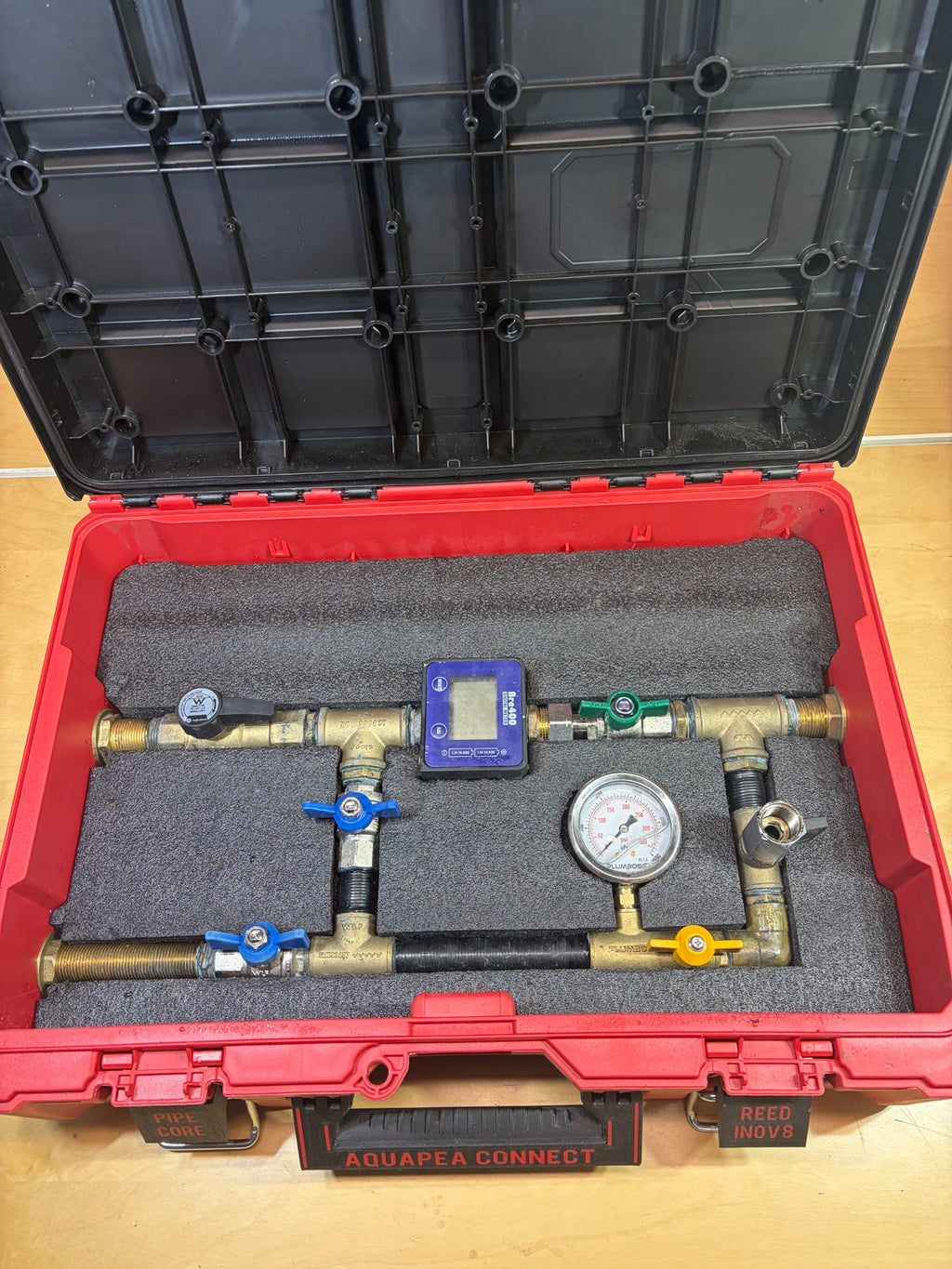 Aquapea Connect open case showing the flow meter, pressure gauge and valve assembly